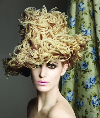 A long blonde wavy curly quirky avant garde hat hairstyle by Vivienne Mackinder