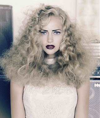 A long blonde wavy coloured platinum messy hairstyle by Icon Diaries